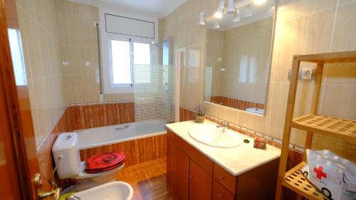 y baño con lavabo, aseo y espejo. en Villa Porta Caeli, en Tarragona