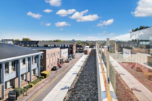 an aerial view of a city with a train tracks at St Martins 2 Bedroom Apartments in Ruislip By 360 Stays in Ruislip