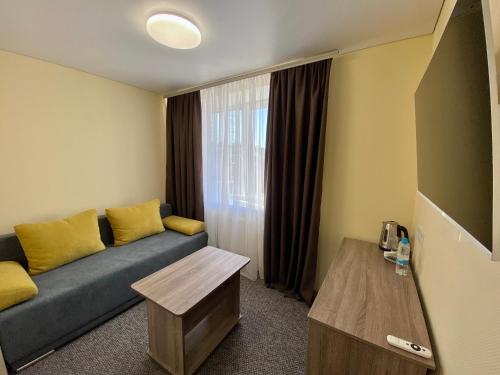 a living room with a couch and a window at Yavir in Poltava