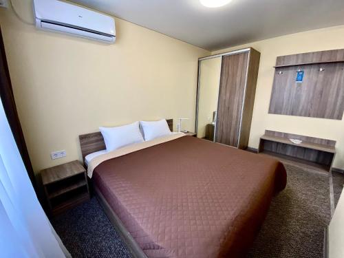 a bedroom with a large bed in a room at Yavir in Poltava