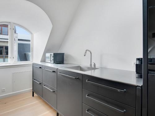 a kitchen with a sink and a window at Sanders King in Copenhagen