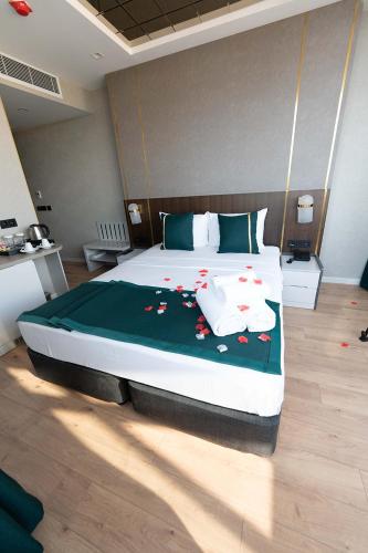 a bedroom with a large bed with red flowers on it at Costera Hotel in Istanbul