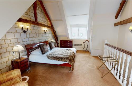 a bedroom with a bed in a room with an attic at Chateau De Montreuil in Montreuil-sur-Mer