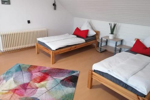 a living room with two beds and a rug at Cozy Apartment near Frankfurt in Niederdorfelden