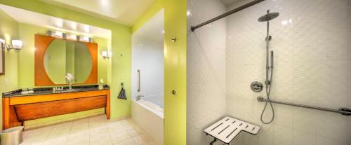 a bathroom with a shower and a sink at Hotel Indigo Jacksonville-Deerwood Park by IHG in Jacksonville