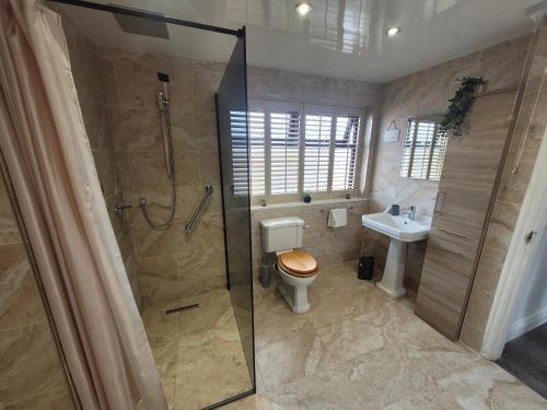 a bathroom with a shower and a toilet and a sink at Luke Stays - Parsons Gardens in Dunston