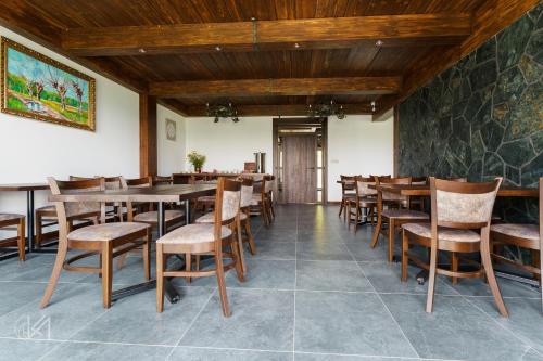 a dining room with wooden tables and chairs at Janasiówka in Kamesznica
