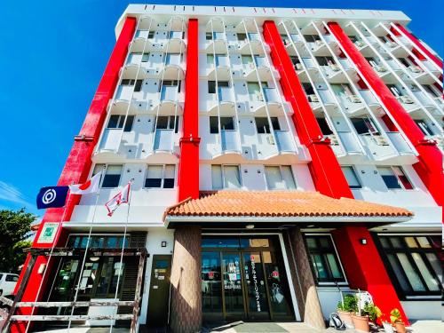 a large building with red and white columns at Hotel Tulip Ishigakijima in Ishigaki Island