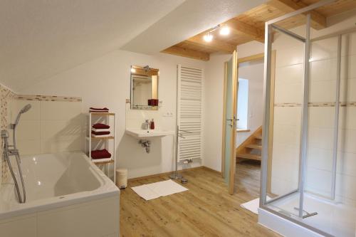 a bathroom with a shower and a bath tub at Grüntenblick in Weitnau