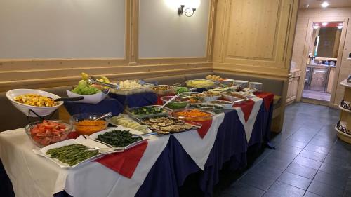 a buffet table with many different types of food on it at Hotel Arisch in Aprica