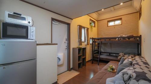 a living room with a couch and a bunk bed at 森と湖の楽園ＷorkshopＣampＲesort in Fujikawaguchiko