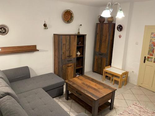 a living room with a couch and a coffee table at Árpád nyaralóház in Sarud