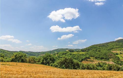 a grassy field with a blue sky and green hills at Corte Liliana in Montegabbione