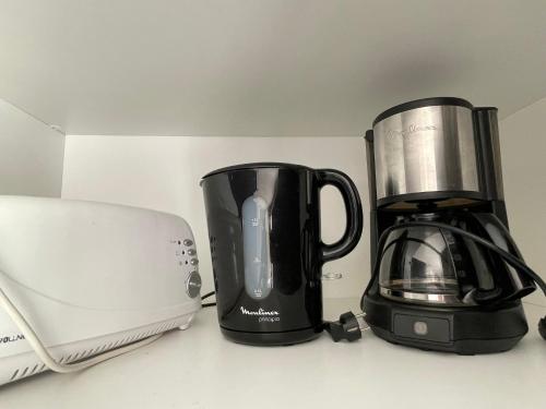 a coffee maker and a blender on a counter at Magnifique vue mer - Tout confort in Pléneuf-Val-André