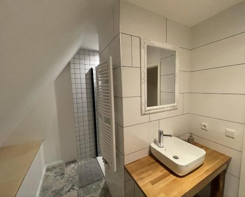 a white bathroom with a sink and a mirror at Oerlinghausen Groß in Oerlinghausen