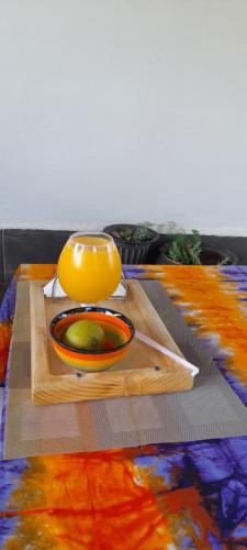 a table with a bowl and a pot on a cutting board at Aivilo Home in Kampala