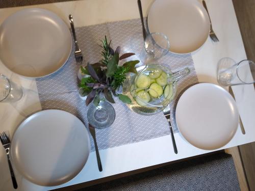 a table with white plates and a bowl of fruit at The Cuddies in Balloch