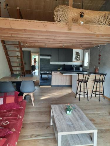 une cuisine et un salon avec un canapé et une table dans l'établissement Studio 40 m 2 près St Guilhem le désert et rivière, à La Boissière