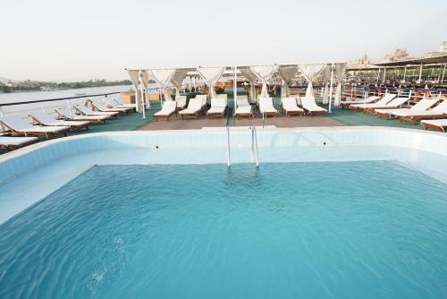 a swimming pool with lounge chairs and a swimming pool at M/S Royal Adventure - Saturday from Luxor 4 or 7 Nights - Wednesday from Aswan 3 or 7 Nights in Luxor