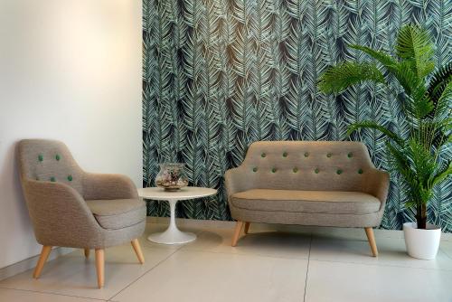 two chairs and a table in a room at Hotel Romagna in Cattolica