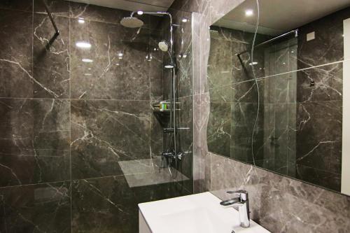 a bathroom with a shower with a sink and a toilet at Phaedrus Living: Luxury Suite Nicosia 502 in Nicosia