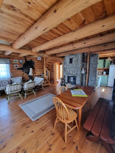 a living room with a wooden table and chairs at Dom letniskowy Uście Gorlickie in Uście Gorlickie