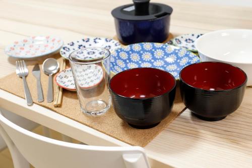 a table with two bowls and plates on a table at 615-13 Higashiboricho, which descends from Kamicho - Vacation STAY 83236 in Kyoto