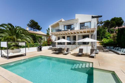 a villa with a swimming pool in front of a house at 2550 Lichtdurchflutete Villa in Santa Ponsa Nova in Santa Ponsa
