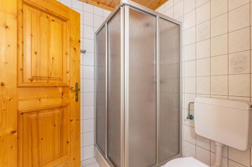 a shower with a glass door in a bathroom at Ferienwohnung Jägermeister in Sankt Martin bei Lofer