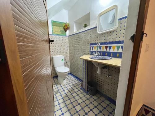a small bathroom with a toilet and a sink at Dar Sunrise Fes in Fès