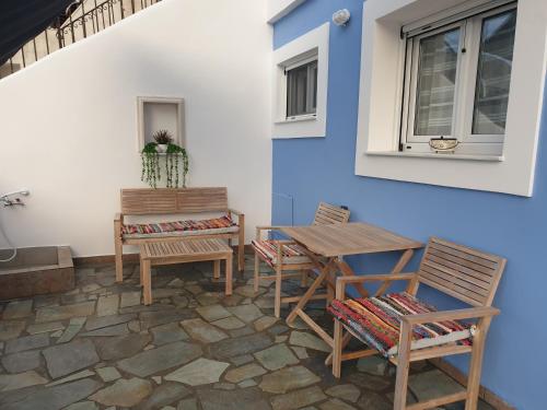 a patio with chairs and a table and a window at Aegean Villita on beach apartment in Kalymnos