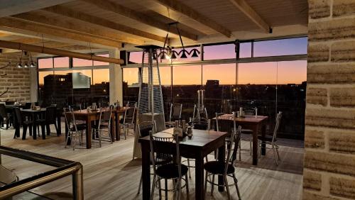 a restaurant with tables and chairs and a view of the city at Casa de Sal - Salt Hotel in Uyuni