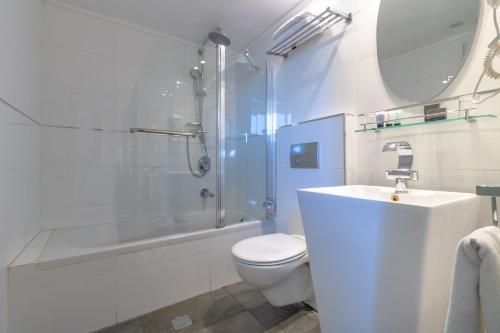 a bathroom with a toilet and a shower and a sink at Agripas Boutique Hotel in Jerusalem