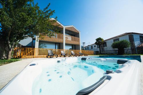a hot tub in front of a building at Casa João Eusébio 1 in Ponte de Lima