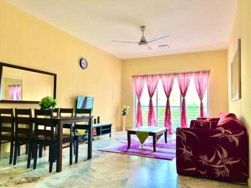 uma sala de estar com uma mesa e uma sala de jantar em PD VIP Pool View w WiFi - Anugerah Staycation em Porto Dickson