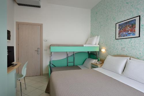 a bedroom with a bed and a bunk bed at Hotel Romagna in Cattolica