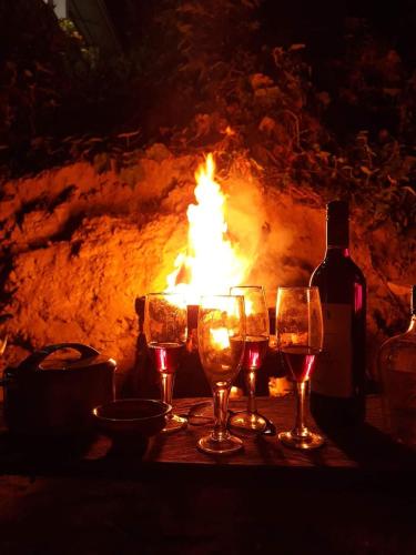 a table with wine glasses and a fire place at Tenam Garden homestay in Kalimpong
