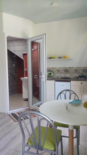 a kitchen with a table and chairs and a bathroom at Borjomi Nest 1 in Borjomi