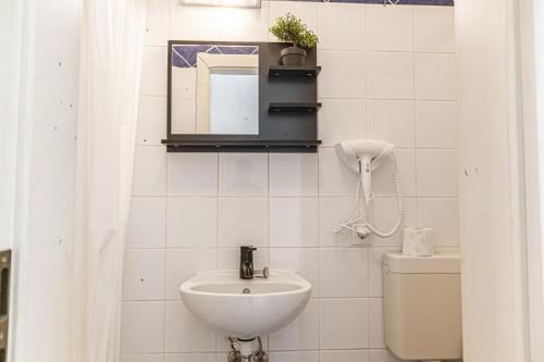 a white bathroom with a sink and a toilet at Smart 2BR Apt. Perfect for Longstays near Rennweg in Vienna