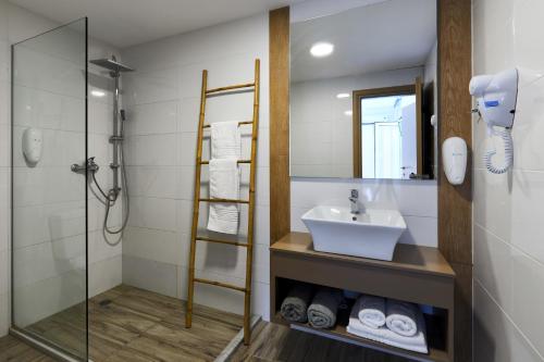 a bathroom with a sink and a shower at Blu Acqua Hotel in Agios Nikolaos