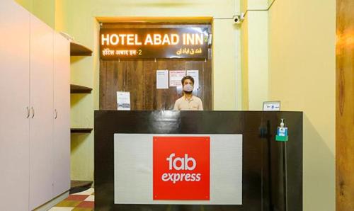 a man wearing a face mask in a hotel room at FabExpress Gateway Inn in Mumbai