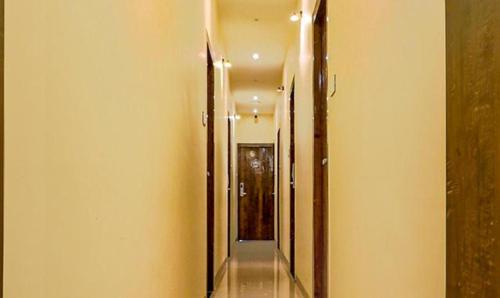 an empty hallway with two mirrors and a hallway with a hallway at FabExpress Gateway Inn in Mumbai