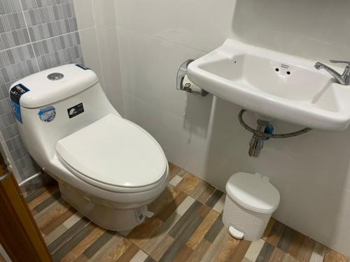 a bathroom with a toilet and a sink at Phu Thai Resort in Sukhothai