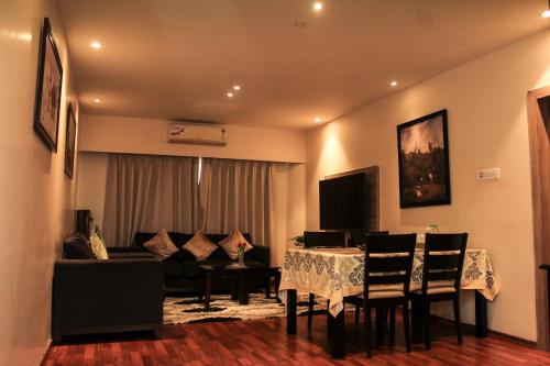 a living room with a table and a couch at Hotel Tea County in Dibrugarh