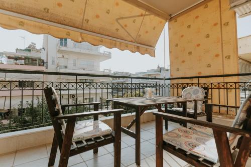 a table and chairs on a balcony with a view at MARIAM APARTMENT in Thessaloniki