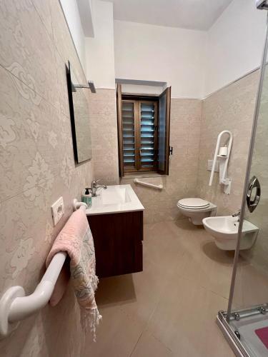 a bathroom with a sink and a toilet at Casa Celestina in Marina di San Lorenzo