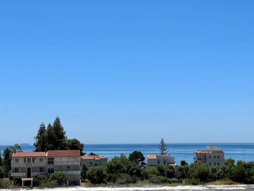 a group of buildings on a beach with the ocean in the background at Casa Celestina in Marina di San Lorenzo