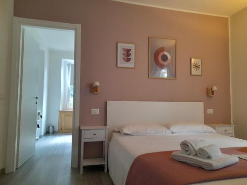 a bedroom with two beds with towels on them at CA' DEL VINO Rooms- Varzo in Varzo