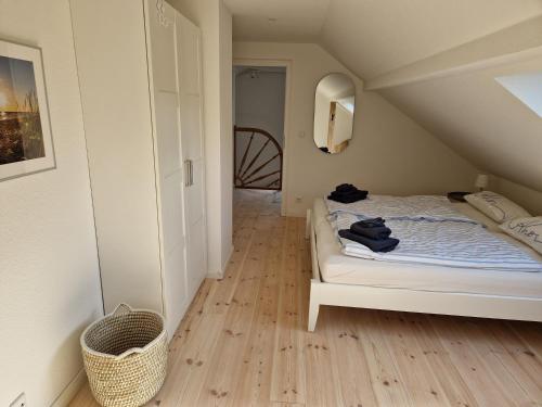a bedroom with a white bed in a attic at Ferienhaus Meerzeit in Gelting