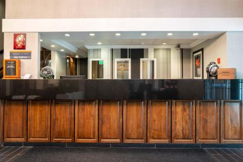 a lobby with a bar with wooden cabinets at Sandman Hotel Revelstoke in Revelstoke